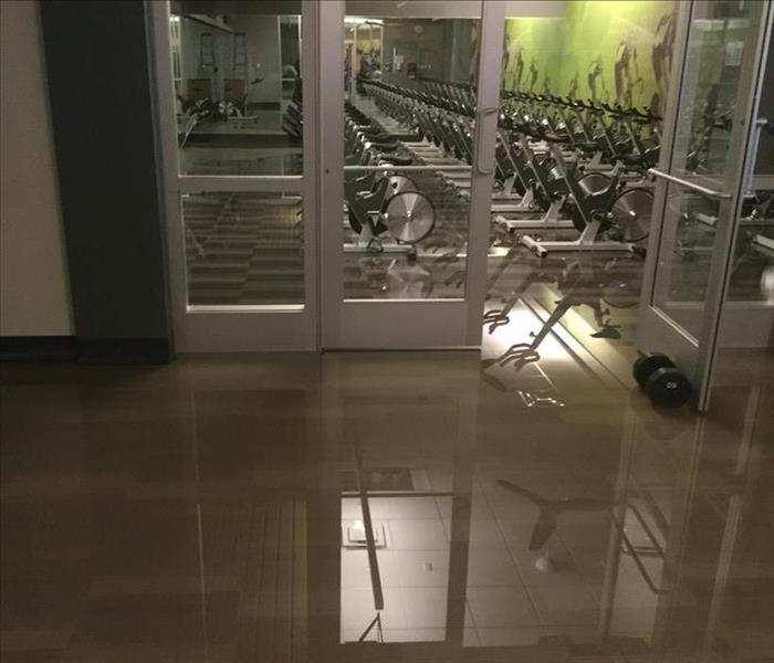 Room in a gym with standing water.