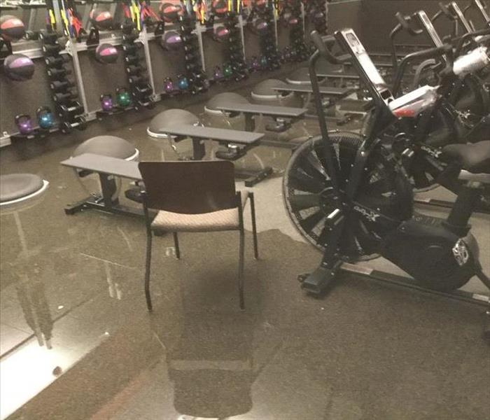 Gym equipment standing in pool of water.