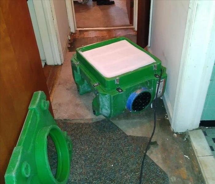 Green equipment set up in hallway.